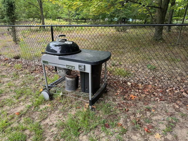Charcoal grill in the fenced backyard
