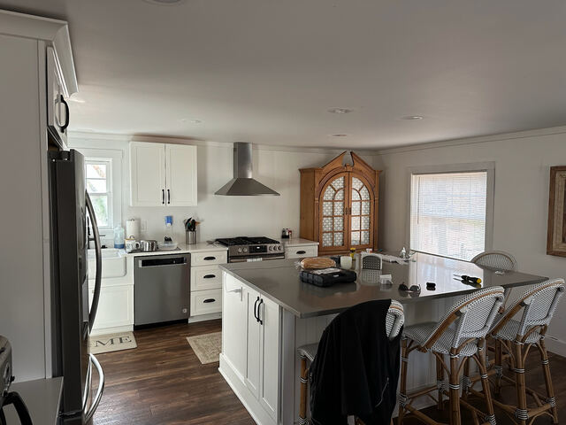 Kitchen with island seating and stainless range