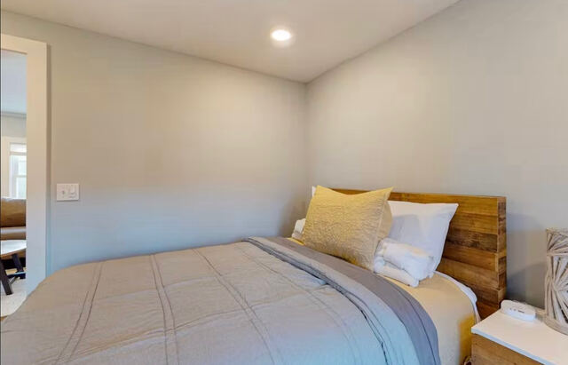 Bedroom with wood-accent bed frame