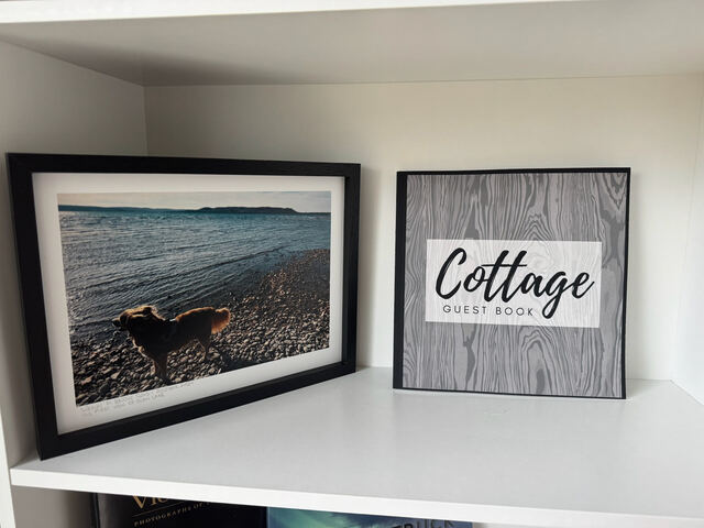 Guest book and beach-themed decor shelf