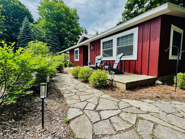 Summer exterior with stone walkway and greenery